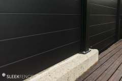 Sleek-privacy-fence-on-concrete-wall